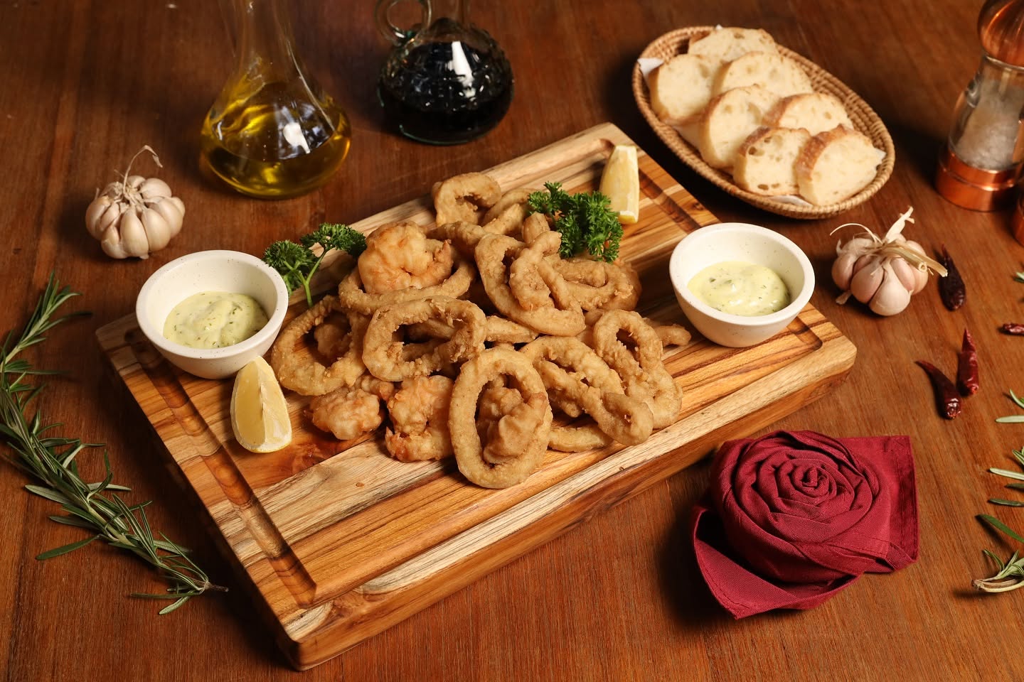 Fritto misto — calamari and shrimp on wooden board at Bellini
