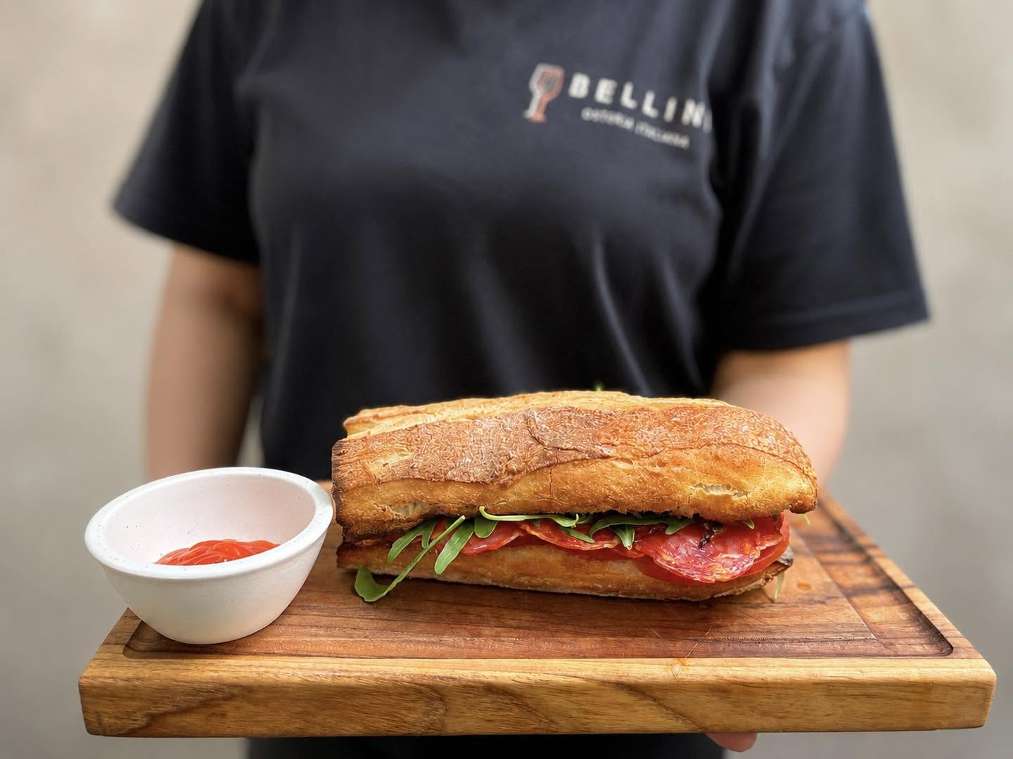 Bellini panino sandwich served on a wooden board