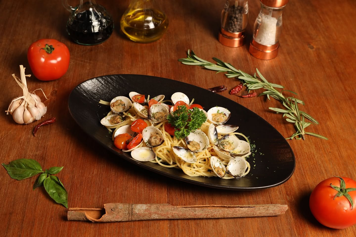 Spaghetti Vongole on black oval plate at Bellini